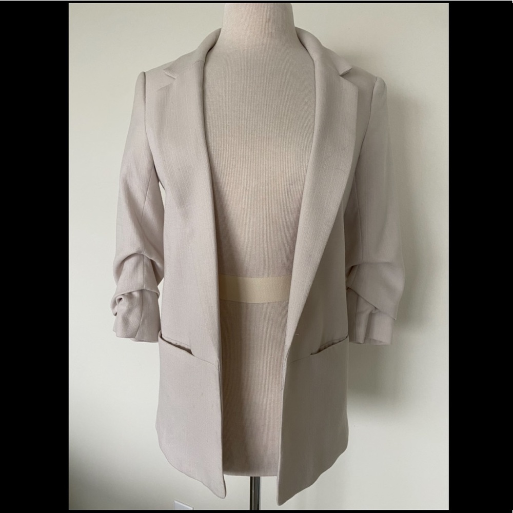 Cream color blazer.